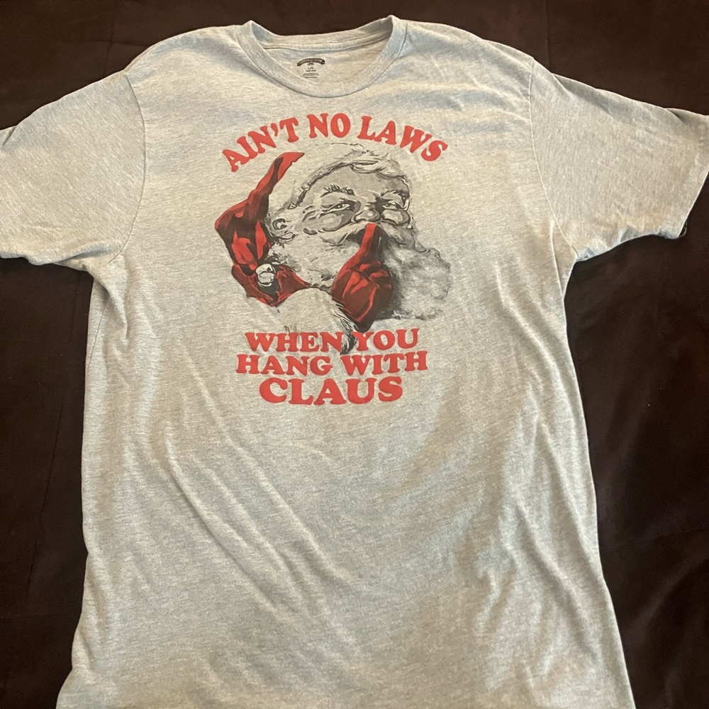 Gray Women’s holiday T-shirt with “Ain’t no laws when you hang with Claus”saying